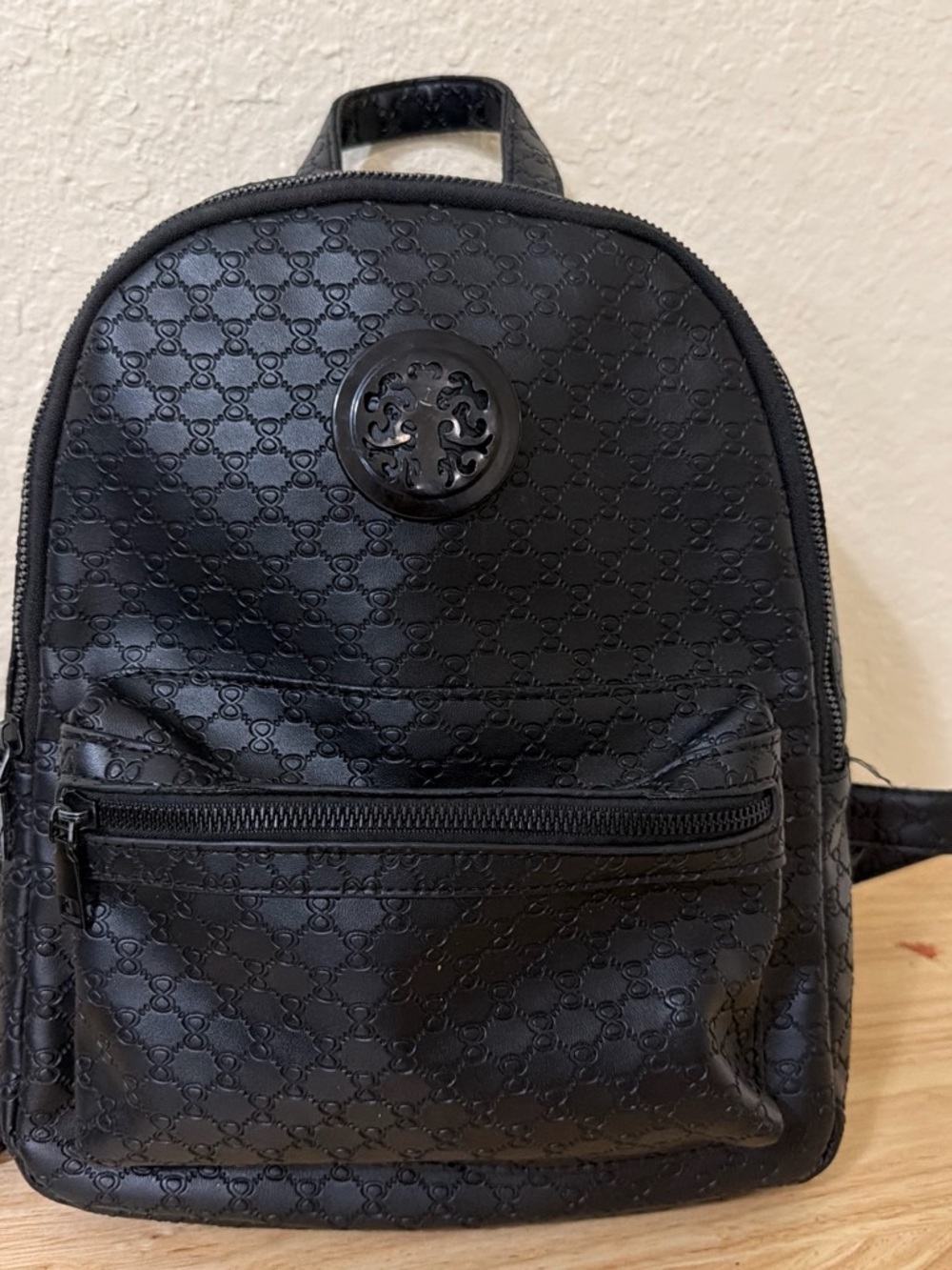 Compact Black Mini Backpack with Embossed Pattern